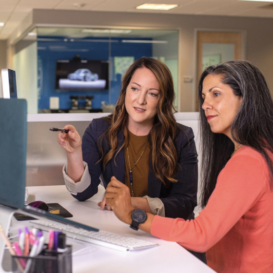 2 colleagues watching to screen